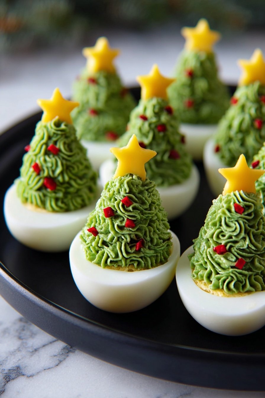 Deviled Egg Christmas Trees, holiday appetizer ideas, festive deviled eggs, Christmas party finger foods, creative holiday snacks - There are eight white half boiled eggs arranged in two rows on a black round plate, each topped with green piped filling shaped like a Christmas tree with textured swirls. Small red pepper pieces are scattered inside the green filling for decoration, with a shiny yellow star made from a thin slice of bell pepper placed on top of each tree. The plate sits on a white marbled surface. photo taken with an iphone --ar 2:3 --v 7